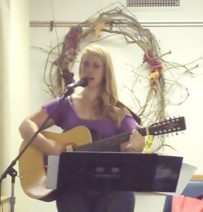 Adrienne Schierer - 3rd generation Aglow woman - leading worship at an Aglow retreat - all generations have their place together